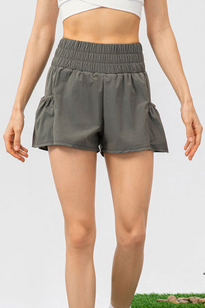 Gathered waistline active shorts in Matcha Green with ruffled pockets and a relaxed fit.