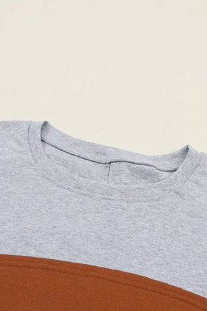 Maternity shirt in gray and mustard colorblock with crew neck and bishop sleeves.