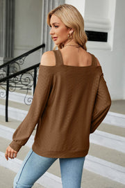 Brown textured open shoulder blouse with square neckline and long sleeves.