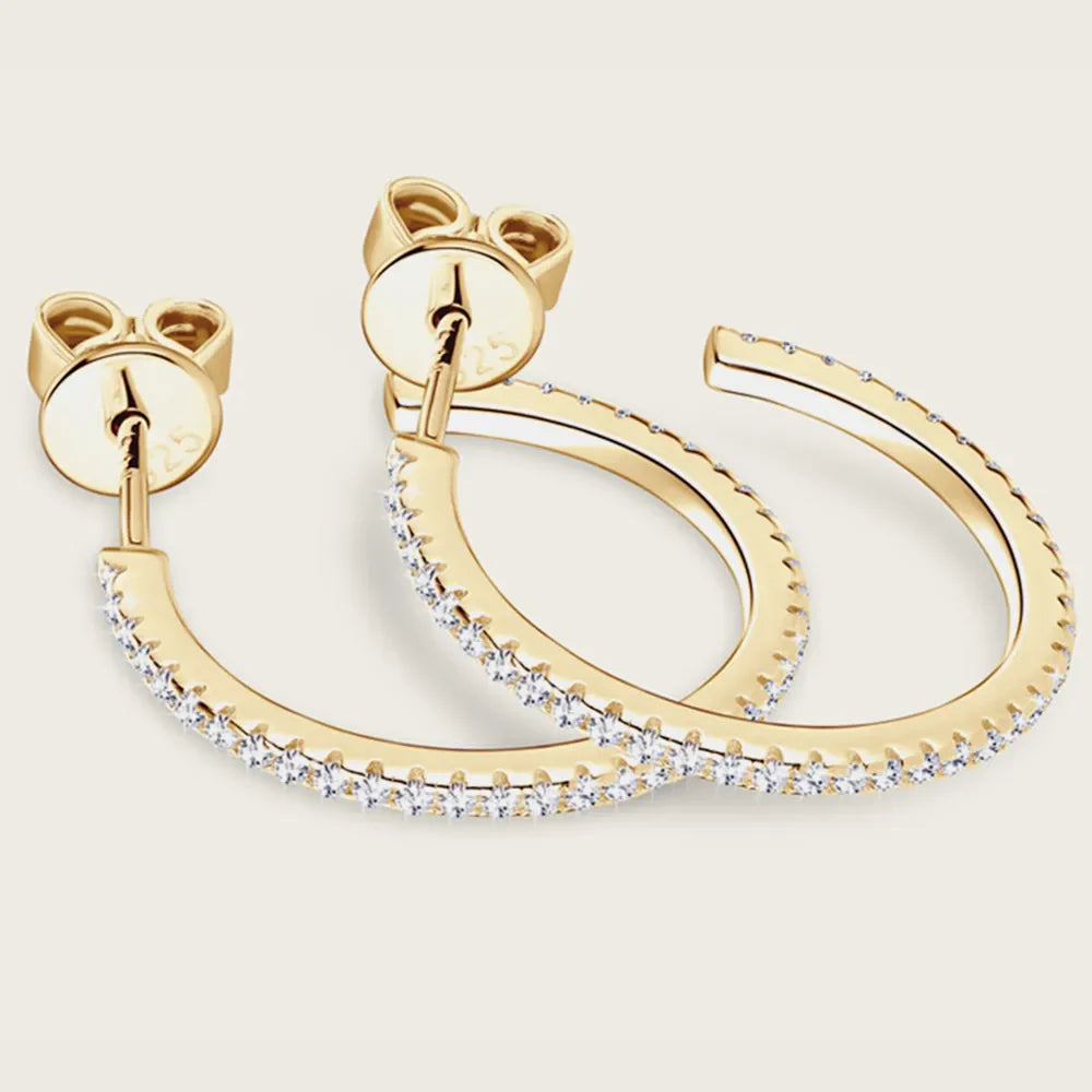 Gold C-hoop earrings with pavé-set cubic zirconia detail and post backs.