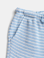 Maternity pants in blue and white stripe waffle knit with drawstring waist and pockets.