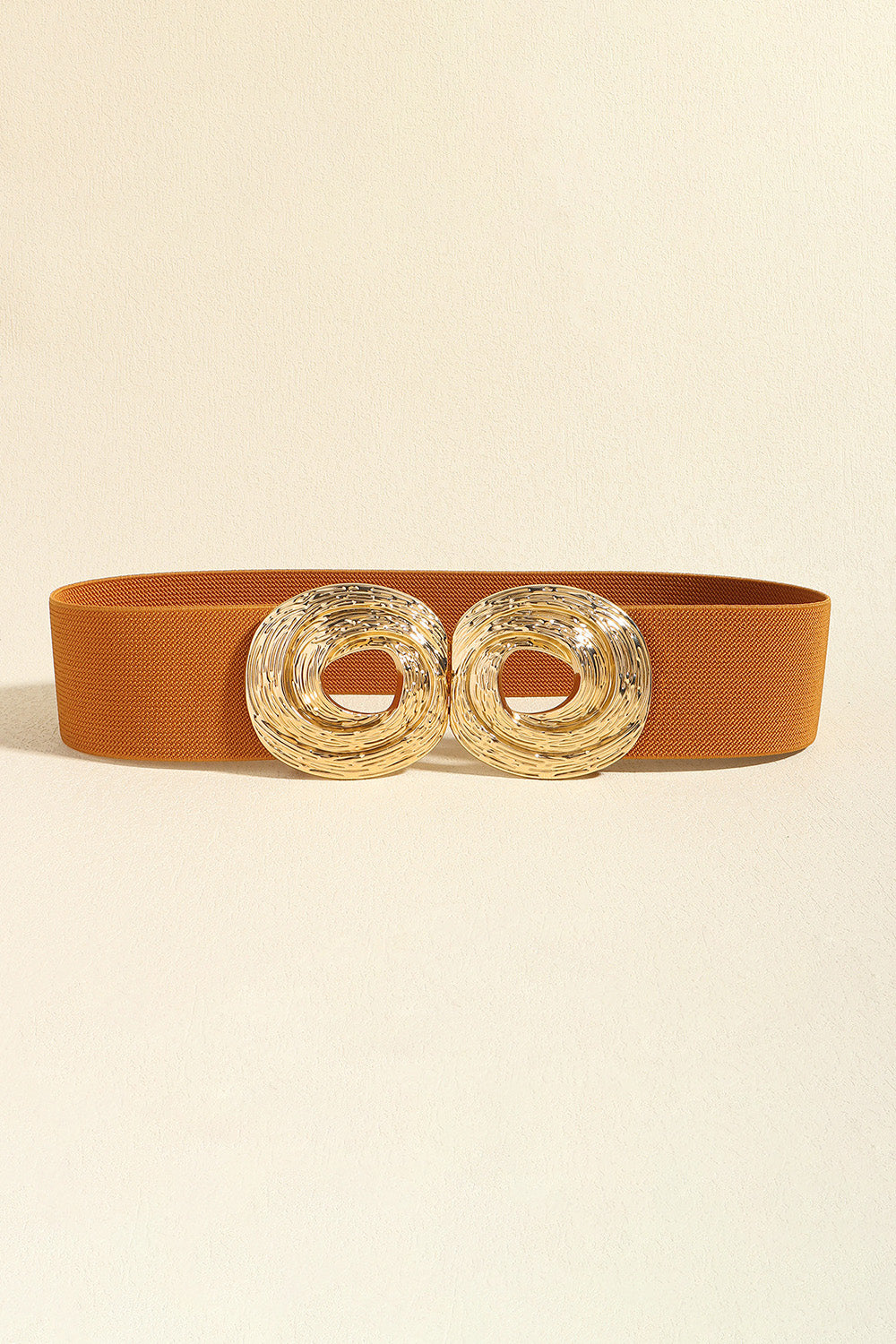 Caramel elastic belt with a double sculptural gold-tone alloy buckle.