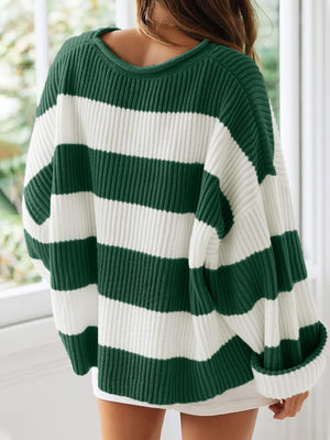 Striped oversized knit sweater in dark green and white with a crew neck.