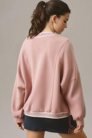 Dusty pink cocoon cardigan with varsity trim and relaxed fit.