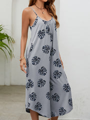 Gray Dawn Monstera print culotte jumpsuit with gathered bust and spaghetti straps.