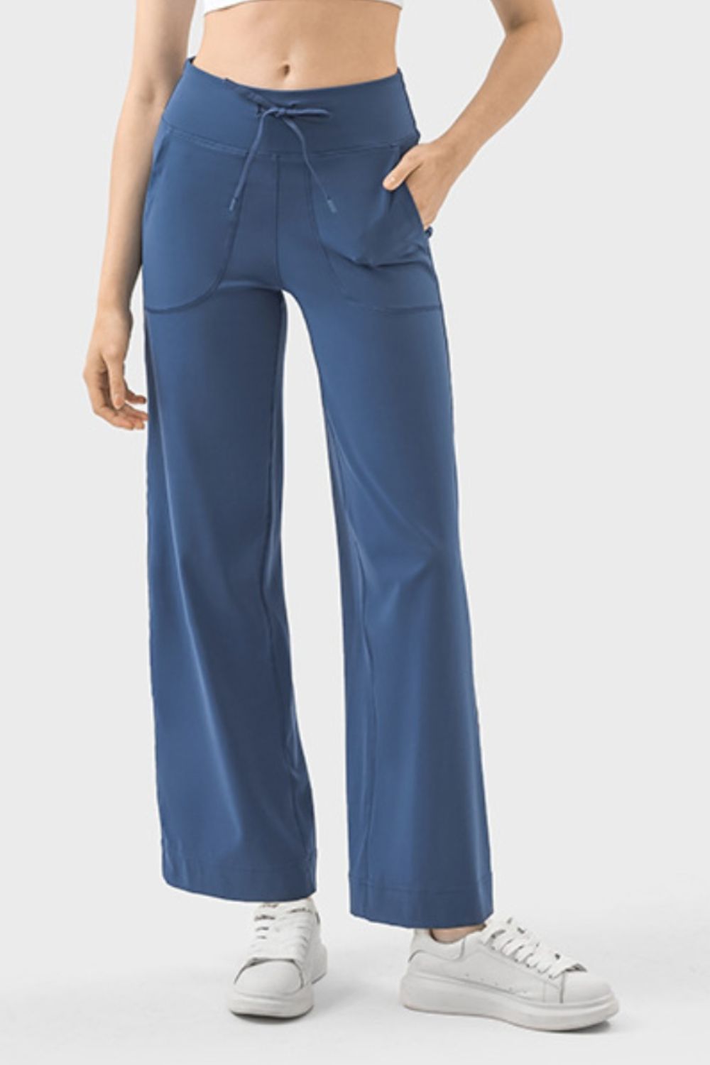 Dusty blue wide-leg drawstring active trousers with pockets and a relaxed fit.