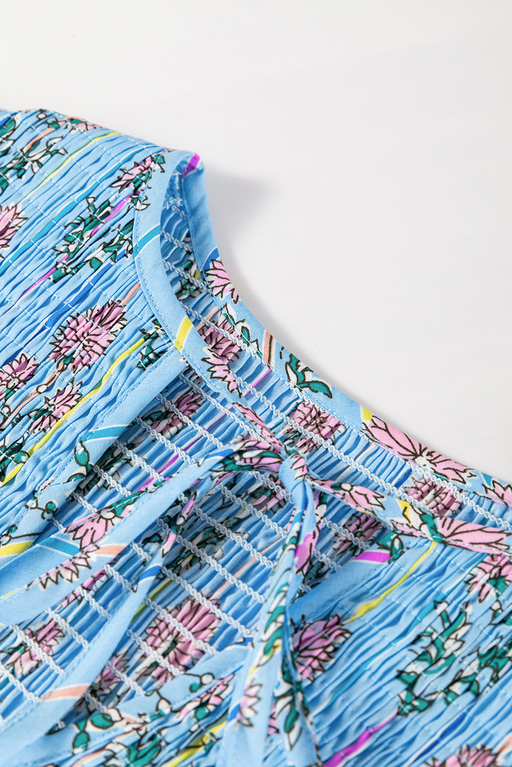 Sky blue floral print smocked yoke blouse with tie detail