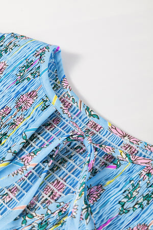 Sky blue floral print smocked yoke blouse with tie detail