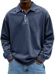 Men's vintage washed long sleeve polo shirt in blue with buttoned neckline.