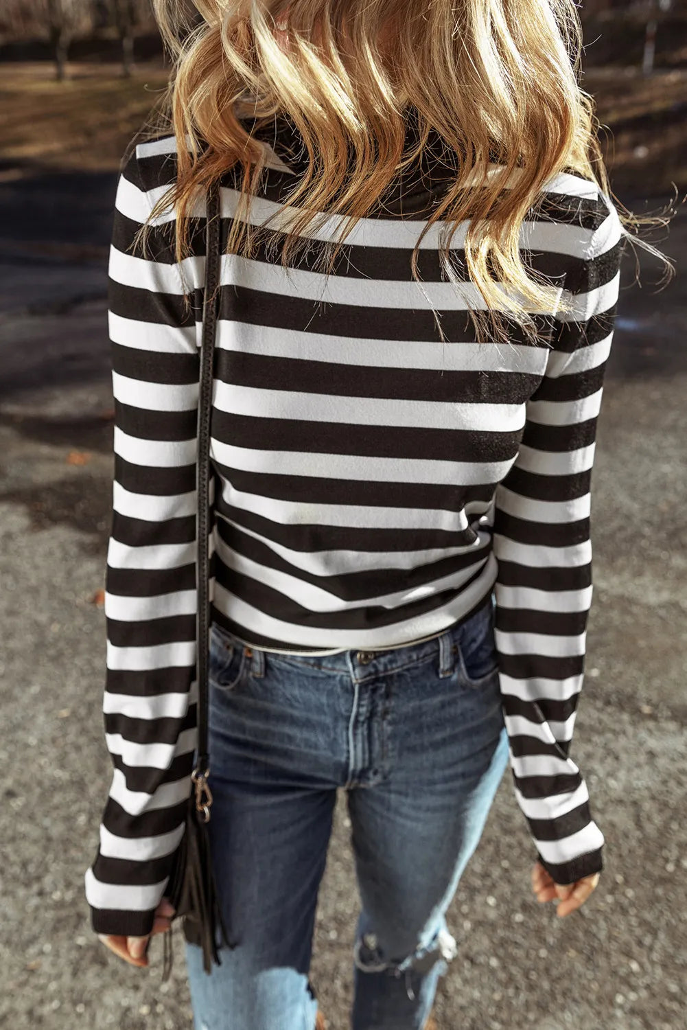Graphic ribbed turtleneck top in black and white stripes with long sleeves.