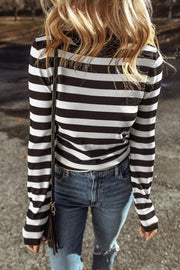 Graphic ribbed turtleneck top in black and white stripes with long sleeves.
