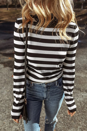 Graphic ribbed turtleneck top in black and white stripes with long sleeves.
