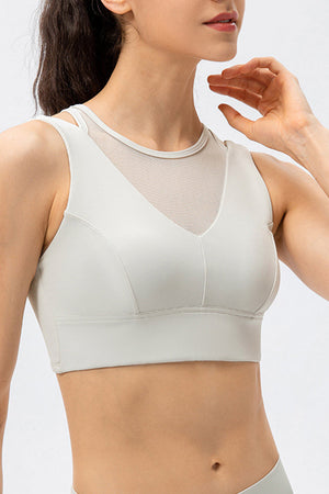 White mesh inset performance bra top with V-neck and racerback straps.