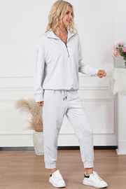 Light gray quarter-zip loungewear co-ord set with drawstring pants and a relaxed fit.