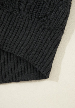 Black openwork knit V-neck pullover sweater with ribbed hem and detail.