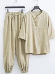 Relaxed fit beige Chinese-inspired men's pants set with drawstring waist and button-up tunic.