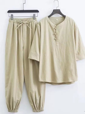 Relaxed fit beige Chinese-inspired men's pants set with drawstring waist and button-up tunic.