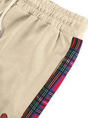Khaki men's sweatpants with plaid side stripe detail and drawstring waist.
