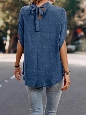 Textured dot back-tie blouse in Dusty Blue with short sleeves and a high neckline.