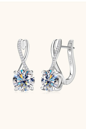 Silver crossover moissanite huggie earrings with diamond accents.