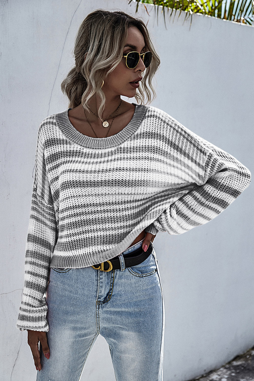 Cropped knit crew neck sweater with horizontal grey and white stripes.