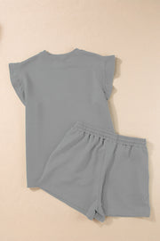 Gray textured loungewear set with flutter sleeve top and elastic waist shorts.
