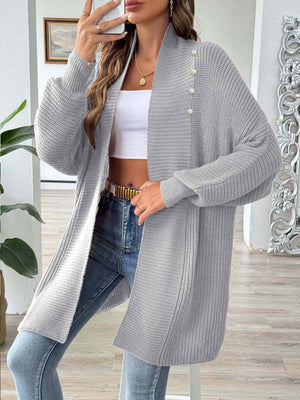 Gray ribbed knit cardigan with pearl buttons and draped neckline.