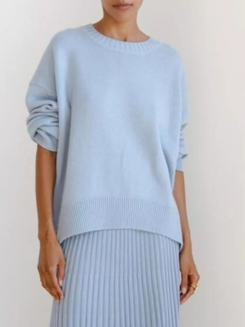 Light blue soft knit sweater with ribbed detailing and crew neck.