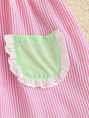 Baby dress in pink and white stripes with a light green pocket and white lace trim.