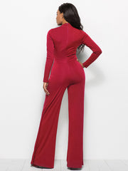 Wine red high-waisted palazzo jumpsuit with long sleeves and a front slit.