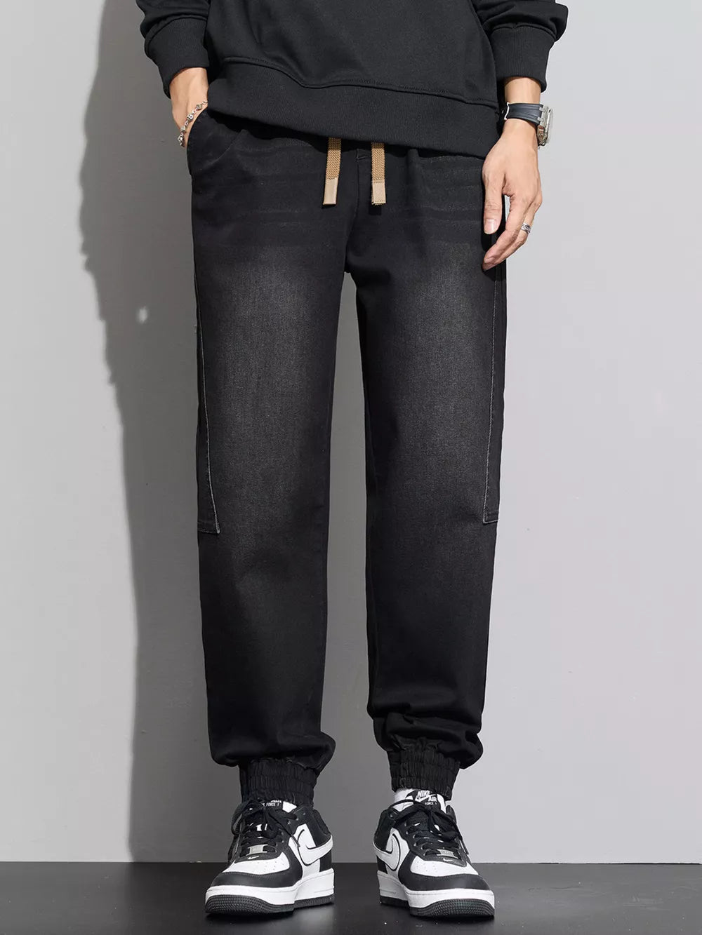Black cotton denim joggers with drawstring waist and elastic cuffs