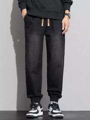 Black cotton denim joggers with drawstring waist and elastic cuffs