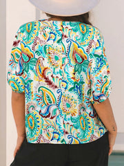 Paisley floral puff sleeve blouse with a V-neck and short sleeves in white with multicolor print.