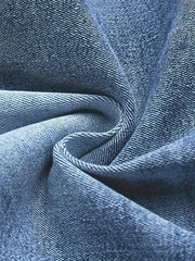 Blue cotton denim fabric detail, showing texture and weave.