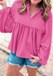 Hot pink textured blouse with gathered yoke, collar, and balloon sleeves.