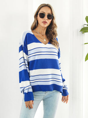 Acrylic V-neck sweater with wide blue and white stripes, long sleeves, and a relaxed fit.