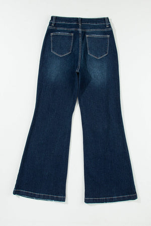 Dark wash denim widecut jeans with frayed hem and pocket details.