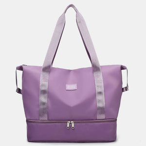 Plum purple dual-compartment travel tote with metallic trim and dual zippers.