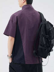 Lightweight outdoor pullover top in violet and navy with short sleeves and a mock neck.