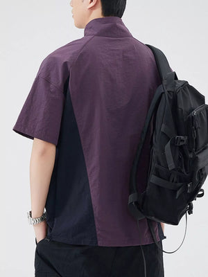 Lightweight outdoor pullover top in violet and navy with short sleeves and a mock neck.