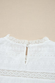 White eyelet yoke blouse with ruffled collar and button back detail.