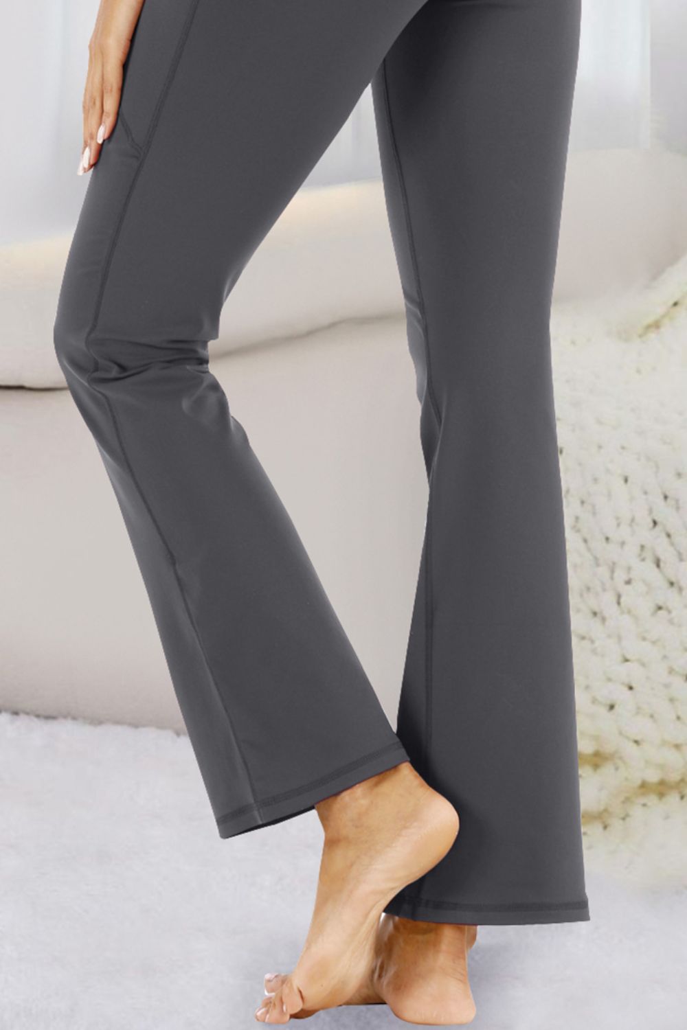 Flare-leg performance trousers in dark gray with side pockets and a casual fit.