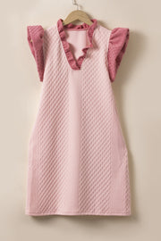 Blush pink trapeze dress with textured diamond pattern, ruffle neckline and sleeves.