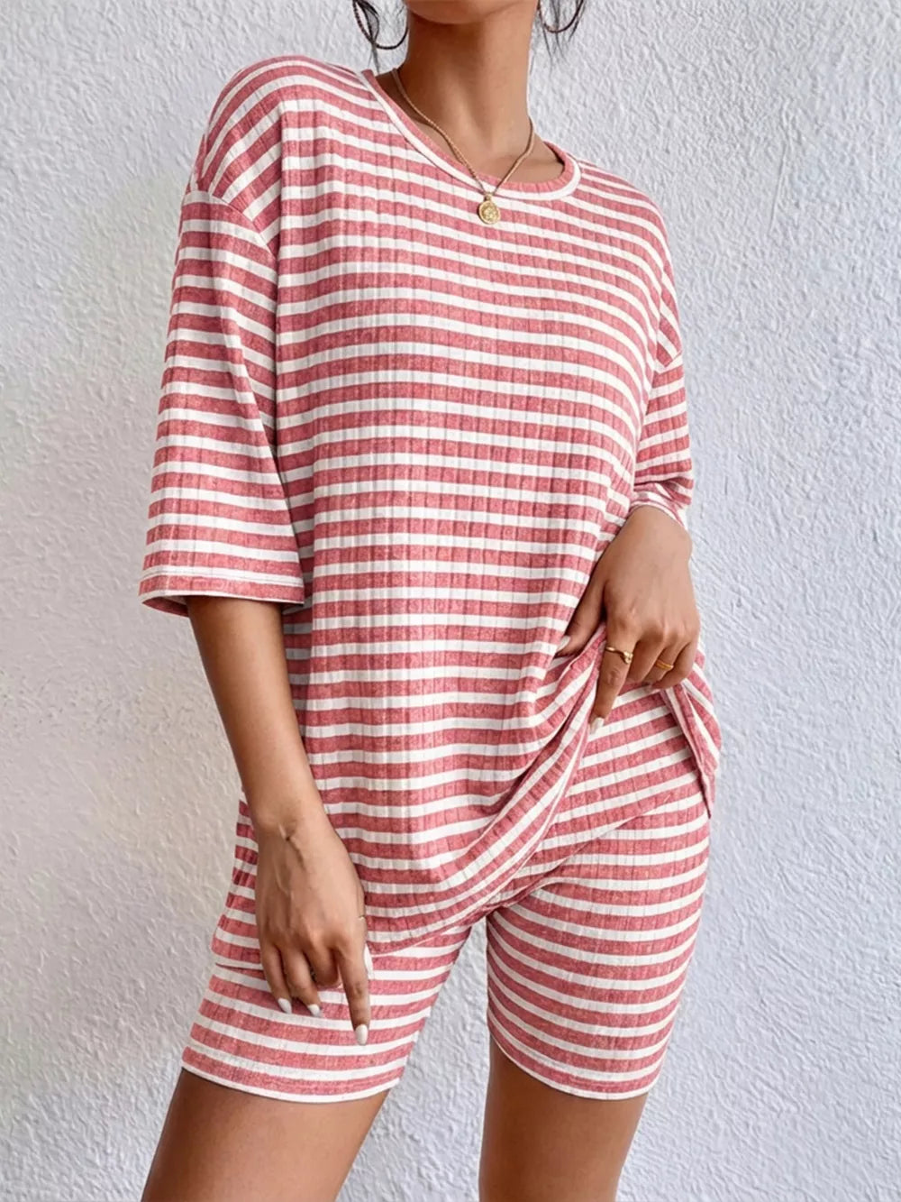 Pink striped two-piece set with elbow sleeves and shorts.