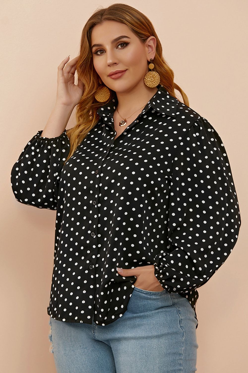 Black polka dot blouse with shirred balloon sleeves and a collared neckline.