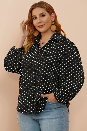 Black polka dot blouse with shirred balloon sleeves and a collared neckline.