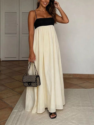 Elegant two-tone maxi dress with spaghetti straps, black bodice and cream skirt.