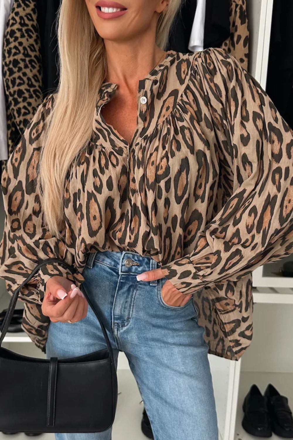 Caramel leopard print blouse with balloon sleeves and button front, styled with jeans and a black handbag.