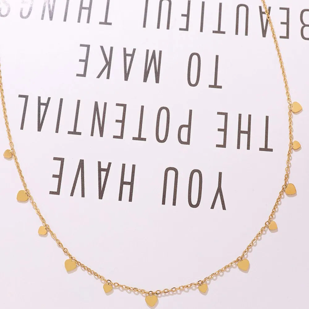 Gold heart charm chain necklace with dangling hearts