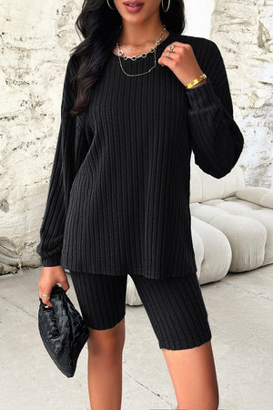 Black ribbed knit loungewear set with long sleeve top and bike shorts.